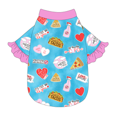 Tee style in a dog friendly pattern that shows witty anti-Valentine phrases and fun images. It's complete with solid pink ruffles on the sleeve edges, as well as trim on the neck and waist.