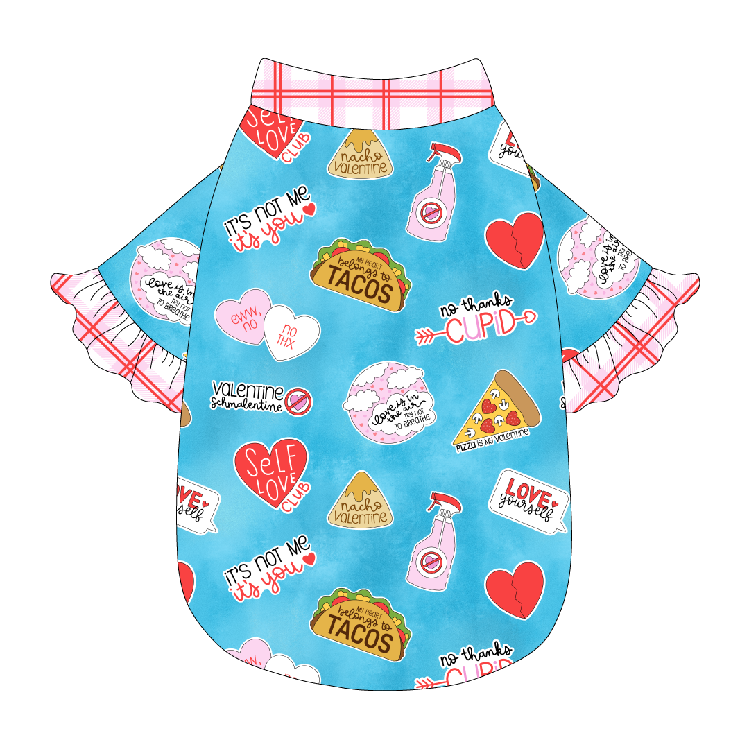 Tee style in a dog friendly pattern that shows witty anti-Valentine phrases and fun images. It's complete with solid red and pink plaid ruffles on the sleeve edges, as well as trim on the neck and waist.