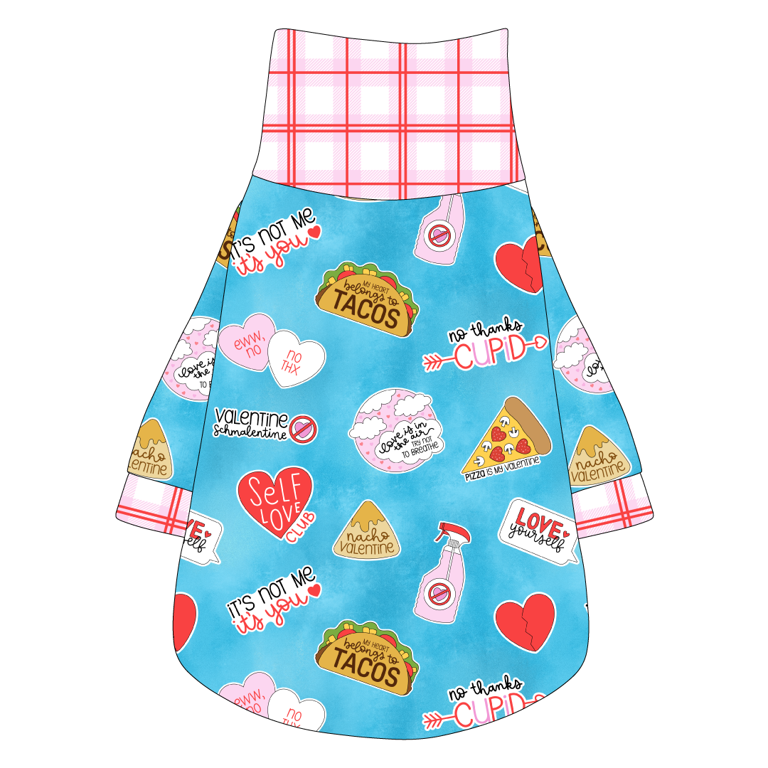 Tee shirt with turtleneck in a dog friendly pattern that shows witty anti-Valentine phrases and fun images. It's complete with red and pink plaid trim on the neck, sleeves and waist.