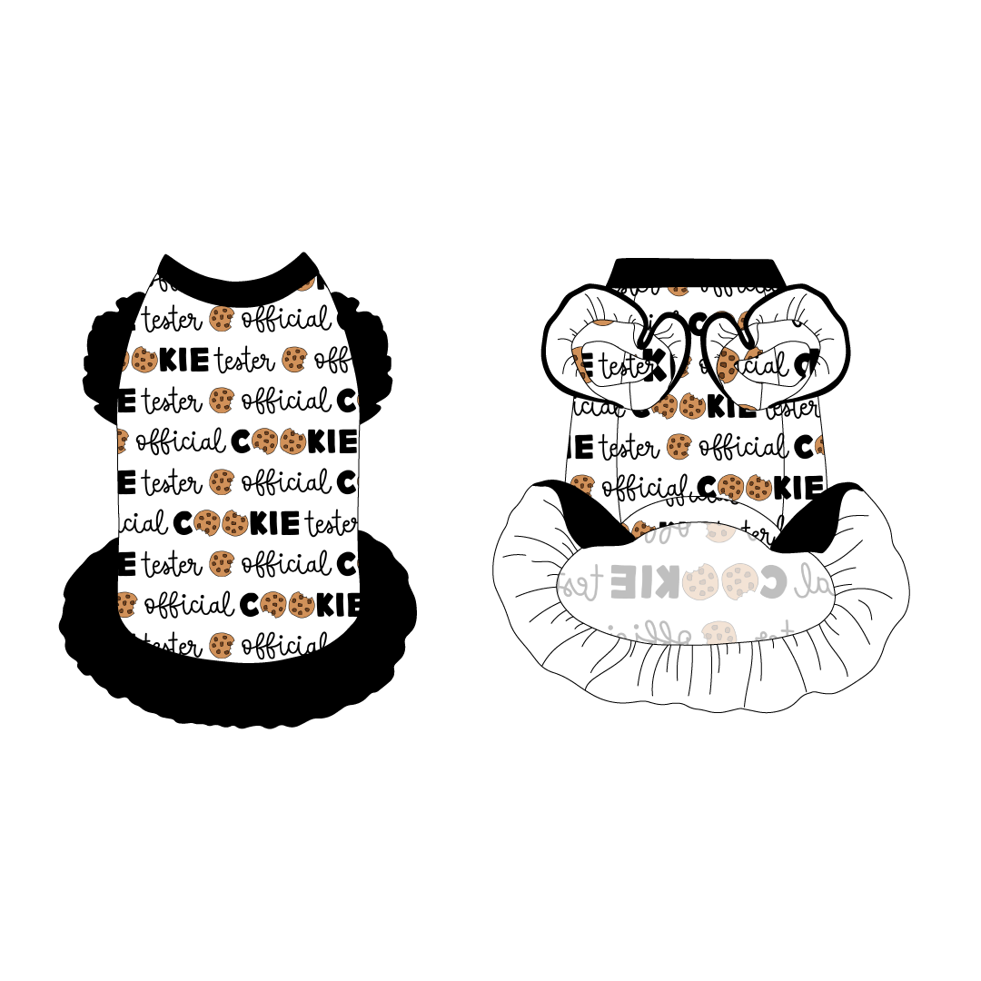 Dress with ruffle accents on the shoulders and girly ruffle skirt in a dog friendly pattern that shows the text Official Cookie Tester, using two cookies for letter “o” in cookies, on a white background. It's complete with black trim on the neck and ruffles, as well as official cookie tester trim under the shoulder ruffles.