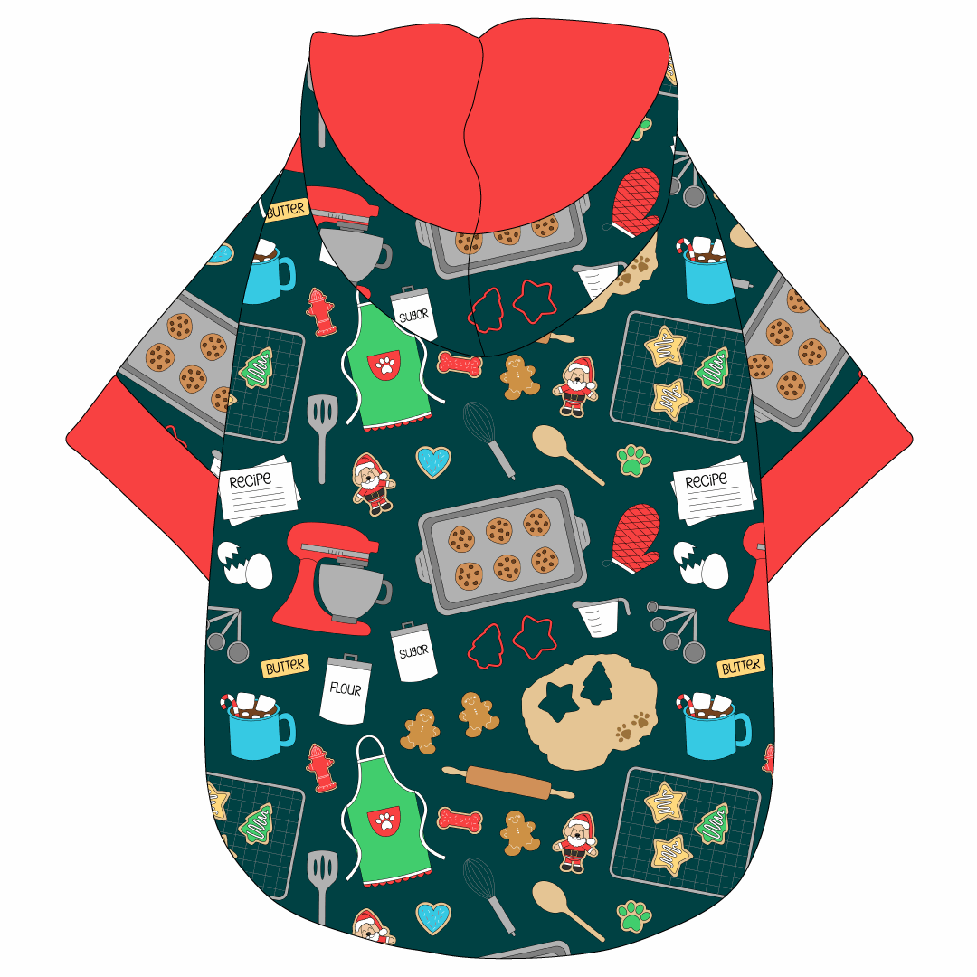 Hoodie in a dog friendly pattern that shows cookies baking, a light green apron, recipe cards and more on a deep emerald background. It's complete with a hood lined in red. Red trim is on the waist and sleeves.