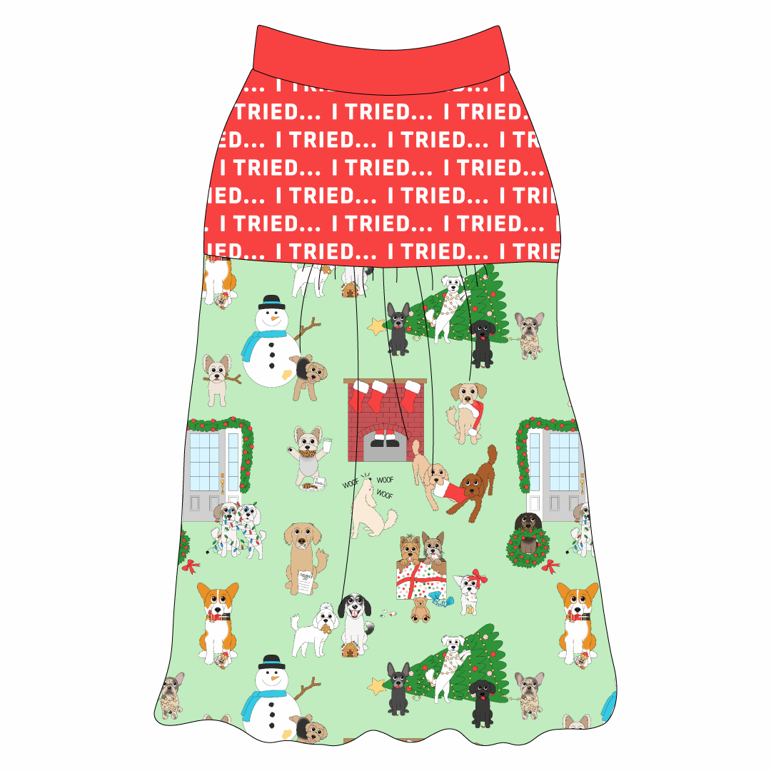 Tank style in a dog friendly pattern that shows the different dog breeds being naughty at Christmas.  Some are getting in gifts, some knocked over the tree, some are tangled in lights, and more. Design is on a light green background. It's complete with red fabric that reads I Tried in white on the upper back and gathering at the yoke. Red trim is on the neck and shoulders.