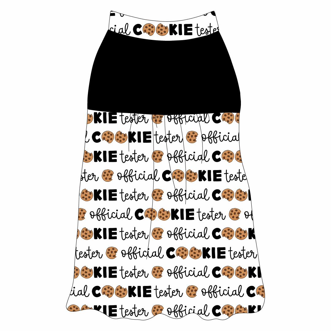 Tank style in a dog friendly pattern that shows the text Official Cookie Tester, using two cookies for letter “o” in cookies, on a white background. It's complete with solid black on the upper back and gathering at the yoke. Official cookie tester trim is on the neck and shoulders.