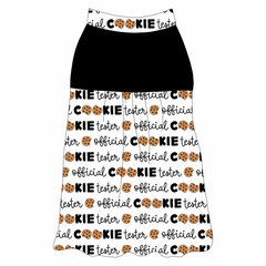 Tank style in a dog friendly pattern that shows the text Official Cookie Tester, using two cookies for letter “o” in cookies, on a white background. It's complete with solid black on the upper back and gathering at the yoke. Official cookie tester trim is on the neck and shoulders.