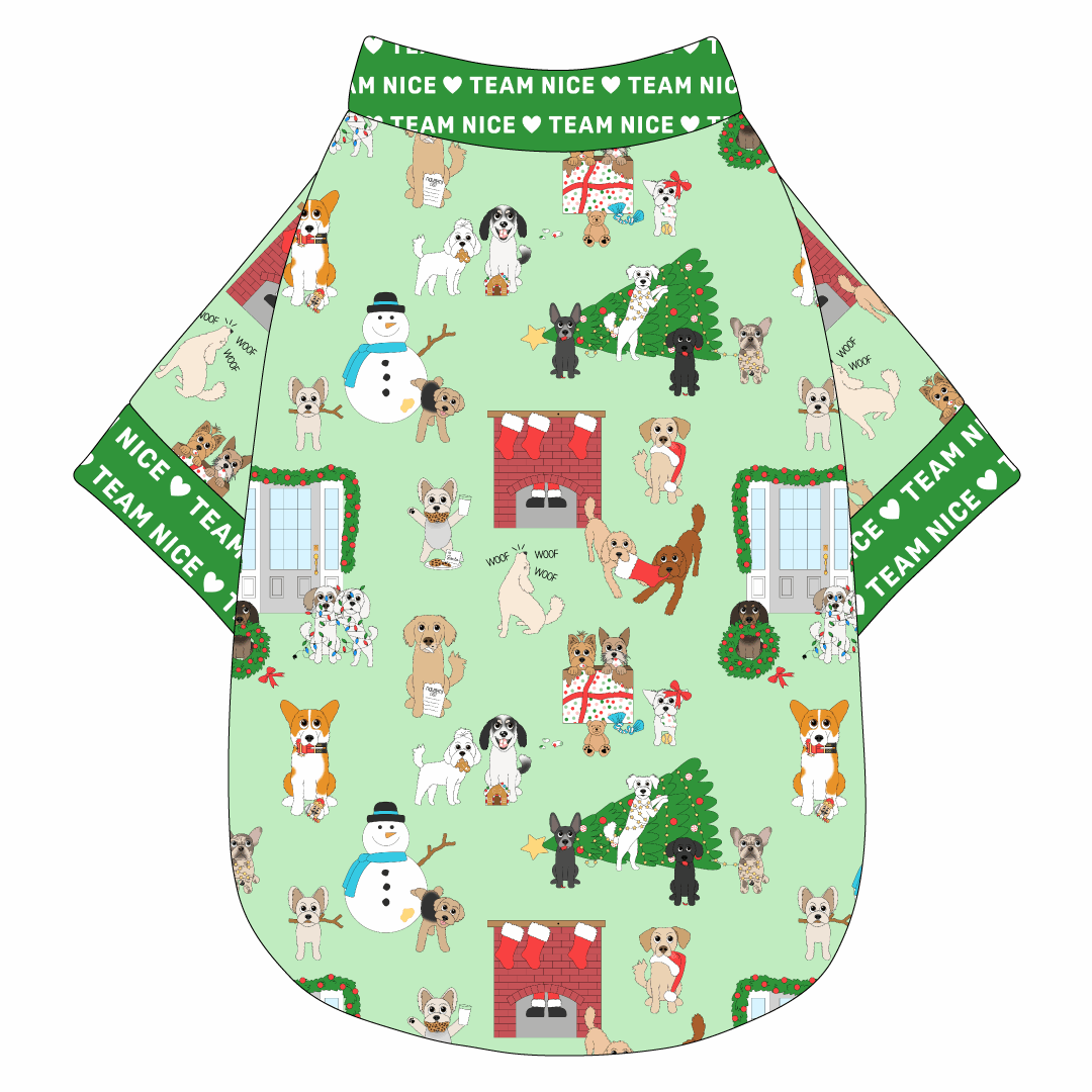 Tee shirt in a dog friendly pattern that shows the different dog breeds being naughty at Christmas.  Some are getting in gifts, some knocked over the tree, some are tangled in lights, and more. Design is on a light green background. It's complete with green trim that reads Team Nice in white on the neck, waist and sleeves.