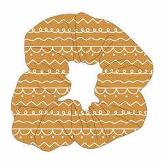 Scrunchie hair accessory in dog friendly pattern that shows a gingerbread design.