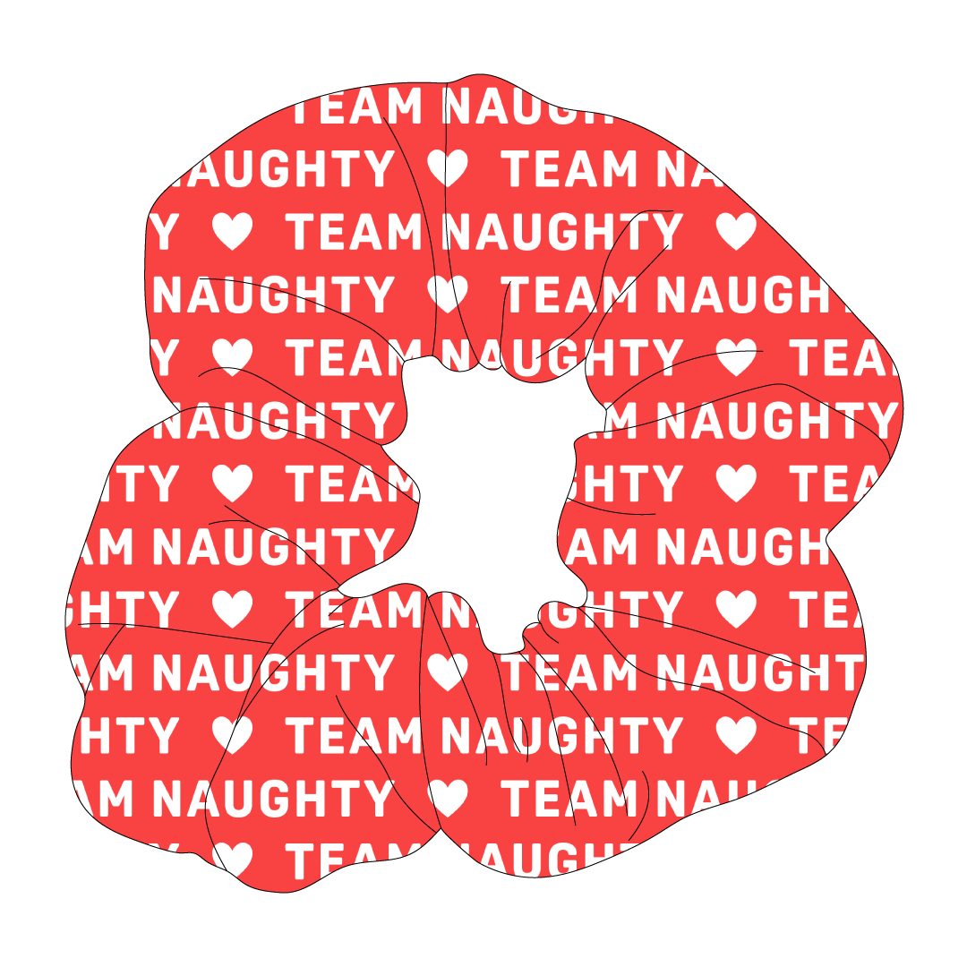 Scrunchie hair accessory in dog friendly pattern that shows a red background with the words Team Naughty written in white.