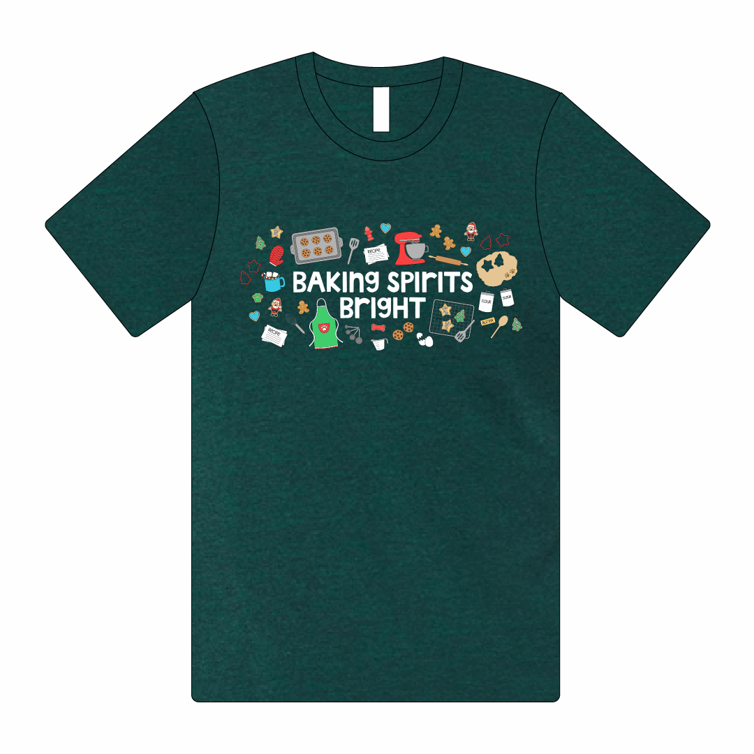 Emerald tee shirt that reads Baking Spirits Bright with design including cookies baking, a light green apron, recipe cards and more across the chest.  Design is written in white.